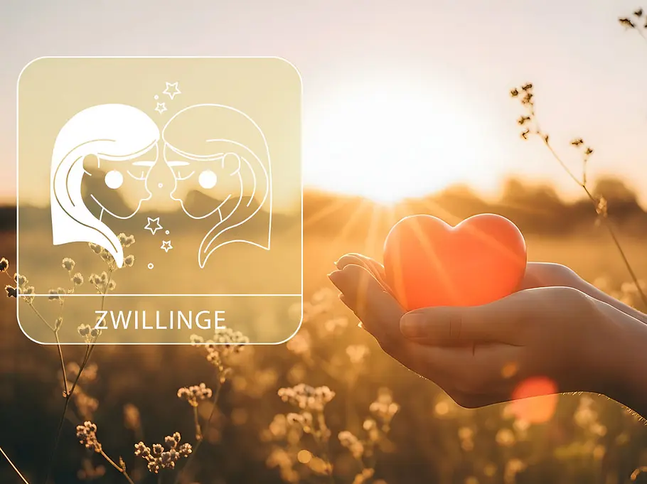 Sternzeichen Zwillinge neben einer Hand, die ein rotes Herz vor einem Feld im Sommer hält