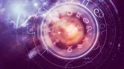 Das Bild zeigt einen leuchtenden astrologischen Tierkreis vor einem kosmischen, sternenbesäten Hintergrund in Violett- und Rottönen. - Foto: nevarpp/iStock Das Bild zeigt einen leuchtenden astrologischen Tierkreis vor einem kosmischen, sternenbesäten Hintergrund in Violett- und Rottönen. - Foto: nevarpp/iStock