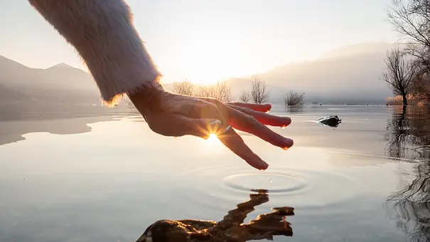 Weibliche Hand verharrt über Wasser als Symbol für das Gesundheitshoroskop - Foto: iStock/swissmediavision