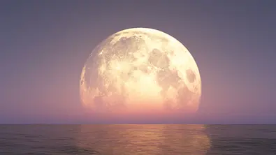 Vollmond steht in lila-farbenden Schimmer über dem Meer - Foto: aleksandar nakovski / AdobeStock