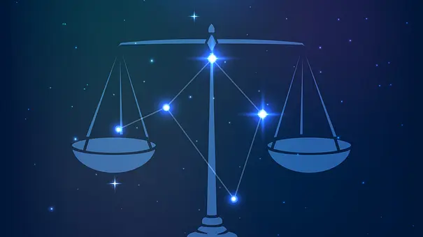 Waage Symbol auf dunkelblauen Hintergrund - Foto: iStock/Lidiia Moor